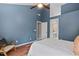 Bedroom boasts hardwood floors and blue walls, with an ensuite bathroom for added convenience and privacy at 1604 Cane Creek Dr, Garner, NC 27529
