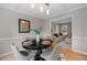 Inviting dining room with modern furnishings, stylish decor, and hardwood floors at 1604 Cane Creek Dr, Garner, NC 27529