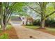 Charming two-story home with an attached garage and mature trees at 1604 Cane Creek Dr, Garner, NC 27529