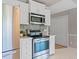 Well-equipped kitchen featuring stainless steel appliances and white cabinetry at 1604 Cane Creek Dr, Garner, NC 27529