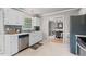 Kitchen features white cabinets, stainless appliances and view to dining room at 1604 Cane Creek Dr, Garner, NC 27529