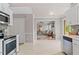 Kitchen with stainless steel appliances, neutral backsplash, and adjacent living space at 1604 Cane Creek Dr, Garner, NC 27529