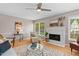 Bright living room showcasing a decorative fireplace and large windows at 1604 Cane Creek Dr, Garner, NC 27529