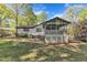 Lovely backyard featuring a screened-in porch, patio, and lush green trees at 1623 Alicary Ct, Cary, NC 27511