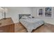 Cozy bedroom featuring a plush bed, hardwood floors, and ample natural light from a window at 1623 Alicary Ct, Cary, NC 27511