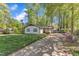 Charming single-story home featuring a well-manicured lawn and a long driveway surrounded by mature trees at 1623 Alicary Ct, Cary, NC 27511