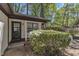 A welcoming front door surrounded by lush greenery and a cozy porch area at 1623 Alicary Ct, Cary, NC 27511