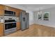Bright kitchen features stainless steel appliances, light countertops and wooden cabinets at 1623 Alicary Ct, Cary, NC 27511