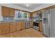 Traditional kitchen with wood cabinets, stainless steel appliances, and a view of the greenery outside at 1623 Alicary Ct, Cary, NC 27511
