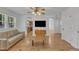 Bright open-concept living room featuring hardwood floors, modern furnishings, and abundant natural light at 1623 Alicary Ct, Cary, NC 27511