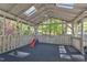 Enclosed outdoor space featuring a ceiling fan, skylights, and backyard views at 1623 Alicary Ct, Cary, NC 27511