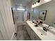 A modern bathroom with dual sinks, gray tile flooring, and a shower/tub combination at 164 E Victory View. Ter, Smithfield, NC 27577