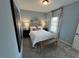 Bedroom features a large canvas artwork, queen bed with neutral bedding, and modern table lamps at 164 E Victory View. Ter, Smithfield, NC 27577