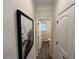 Hallway view leading to powder room; neutral walls, wood floors, and eye catching art at 164 E Victory View. Ter, Smithfield, NC 27577