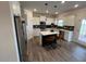 Modern kitchen featuring an island, stainless steel appliances, granite countertops, and lots of cabinet space at 164 E Victory View. Ter, Smithfield, NC 27577
