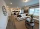 Open-concept living room with cozy seating, view of kitchen, and plenty of natural light at 164 E Victory View. Ter, Smithfield, NC 27577