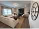 Inviting living room boasts a modern fireplace, stylish furniture, large window, and a unique clock at 164 E Victory View. Ter, Smithfield, NC 27577