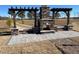 Outdoor fireplace with stone accents and pergola-style structure, enhancing backyard aesthetics at 164 E Victory View. Ter, Smithfield, NC 27577