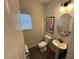 Bright powder room featuring a pedestal sink, round mirror, and a patterned window shade at 164 E Victory View. Ter, Smithfield, NC 27577