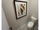 Powder room with modern toilet and framed abstract art at 164 E Victory View. Ter, Smithfield, NC 27577
