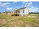 A single Gathering home with backyard featuring an uncovered porch, an electric fan and beautiful landscaping at 172 Royal Ave, Selma, NC 27576