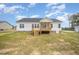 Back exterior of home featuring porch, wood deck and level back yard at 172 Royal Ave, Selma, NC 27576