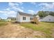 A single Gathering home with backyard featuring an uncovered porch and beautiful landscaping at 172 Royal Ave, Selma, NC 27576