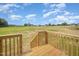 Exterior view of wood deck and stairs leading to a large, level back yard at 172 Royal Ave, Selma, NC 27576