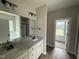 Bathroom featuring double sinks, granite counters, and an inviting bathtub at 172 Royal Ave, Selma, NC 27576
