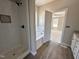 Bathroom featuring tub, shower, and tile accents near the entrance to the bedroom at 172 Royal Ave, Selma, NC 27576