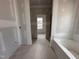 Bathroom with installed tub, drywall, and natural light from the window at 172 Royal Ave, Selma, NC 27576