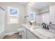 Bathroom with double sink vanity, granite counters, and a large mirror at 172 Royal Ave, Selma, NC 27576