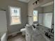 Well-lit bathroom boasts double vanity, granite countertops, and shower-tub combo at 172 Royal Ave, Selma, NC 27576