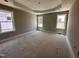 Empty bedroom featuring trim work, neutral paint, and tray ceiling at 172 Royal Ave, Selma, NC 27576