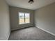 Cozy bedroom with soft carpet, neutral walls, and a bright window at 172 Royal Ave, Selma, NC 27576
