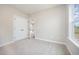 Bright bedroom featuring carpet flooring, a double door closet, and a window at 172 Royal Ave, Selma, NC 27576
