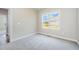 This bedroom has neutral walls, carpeting and a bright window view at 172 Royal Ave, Selma, NC 27576
