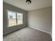 Comfortable bedroom with soft carpet, neutral walls, and a bright window at 172 Royal Ave, Selma, NC 27576