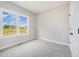 Bright bedroom with plush carpet and large window overlooking the neighborhood at 172 Royal Ave, Selma, NC 27576