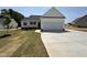 Charming single-story home with a concrete driveway and attached two car garage at 172 Royal Ave, Selma, NC 27576