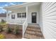 Inviting front porch featuring brick steps, white railing, and view of manicured lawn at 172 Royal Ave, Selma, NC 27576