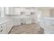 Modern kitchen featuring white cabinets, granite countertops, and view into dining and living area at 172 Royal Ave, Selma, NC 27576
