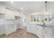 Modern kitchen featuring white cabinets, granite countertops, stainless steel sink, and ample counter space at 172 Royal Ave, Selma, NC 27576
