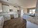 Spacious kitchen featuring white cabinets, granite countertops, and stainless steel sink at 172 Royal Ave, Selma, NC 27576