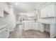 Open-concept kitchen featuring white cabinets, granite countertops, and stainless steel sink at 172 Royal Ave, Selma, NC 27576