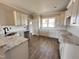 Well-lit kitchen with white cabinets, granite countertops, and hardwood flooring at 172 Royal Ave, Selma, NC 27576