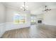 Bright living room featuring a corner fireplace, wood-look flooring, and large windows with scenic views at 172 Royal Ave, Selma, NC 27576