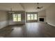 Spacious living room features hardwood floors, ample natural light, and a cozy fireplace at 172 Royal Ave, Selma, NC 27576