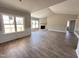 Open-concept living room with fireplace, hardwood floors, and large windows at 172 Royal Ave, Selma, NC 27576