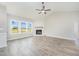 Bright living room with corner fireplace, wood-look flooring, and large windows for natural light at 172 Royal Ave, Selma, NC 27576